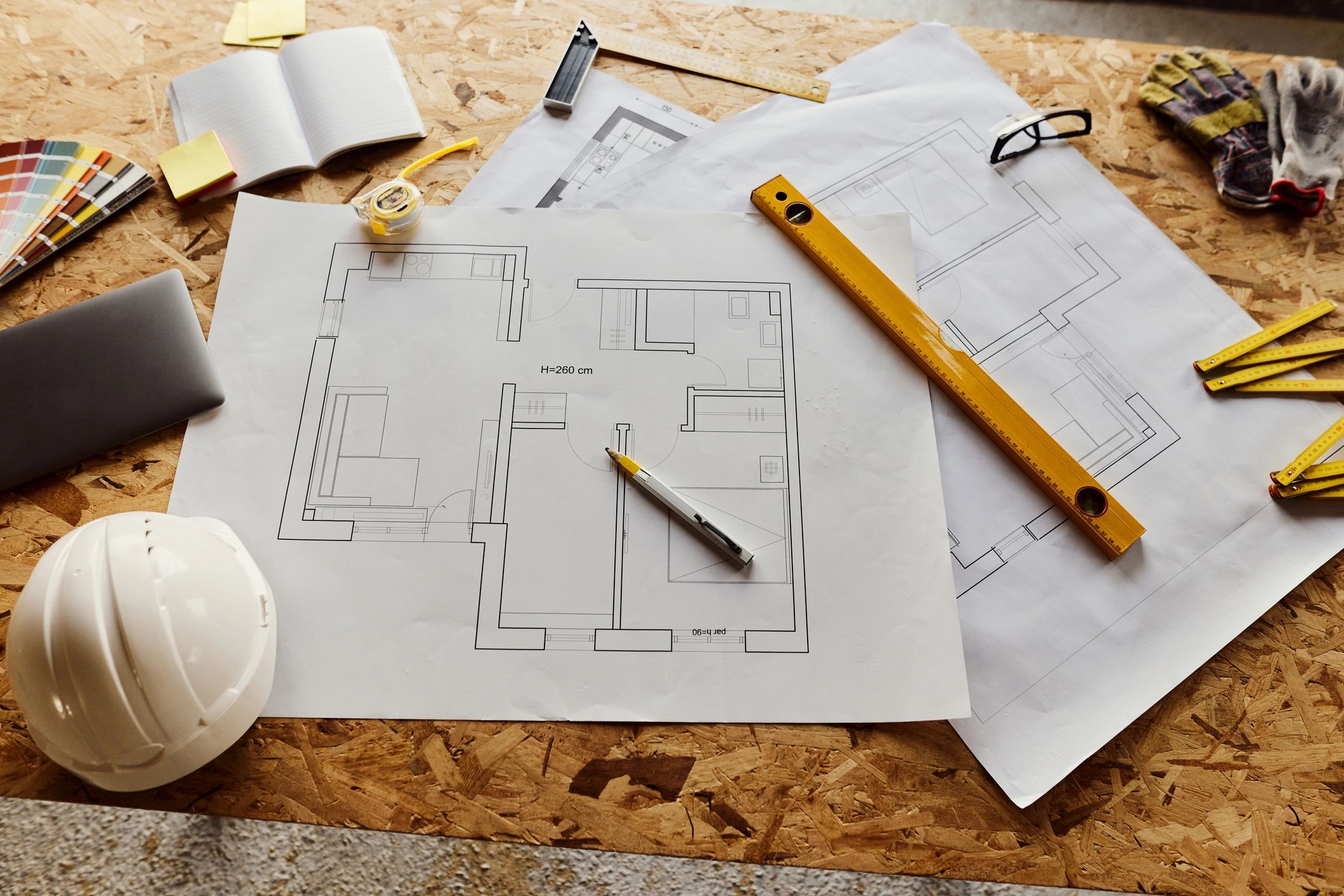 Architectural tools and blueprints on a construction planning desk