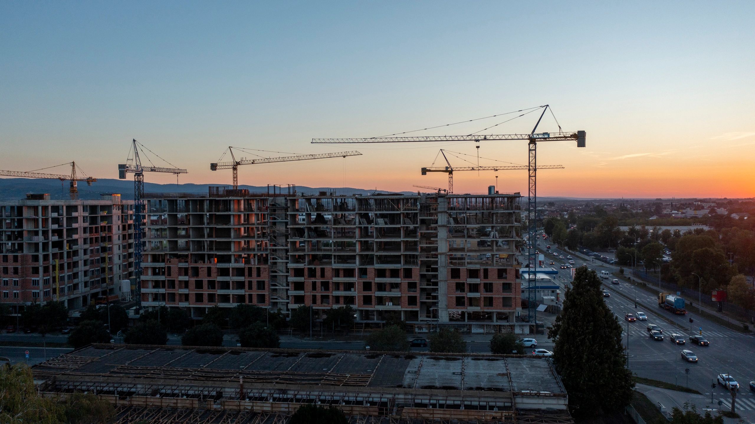 Urban construction site with cranes and multi-story buildings